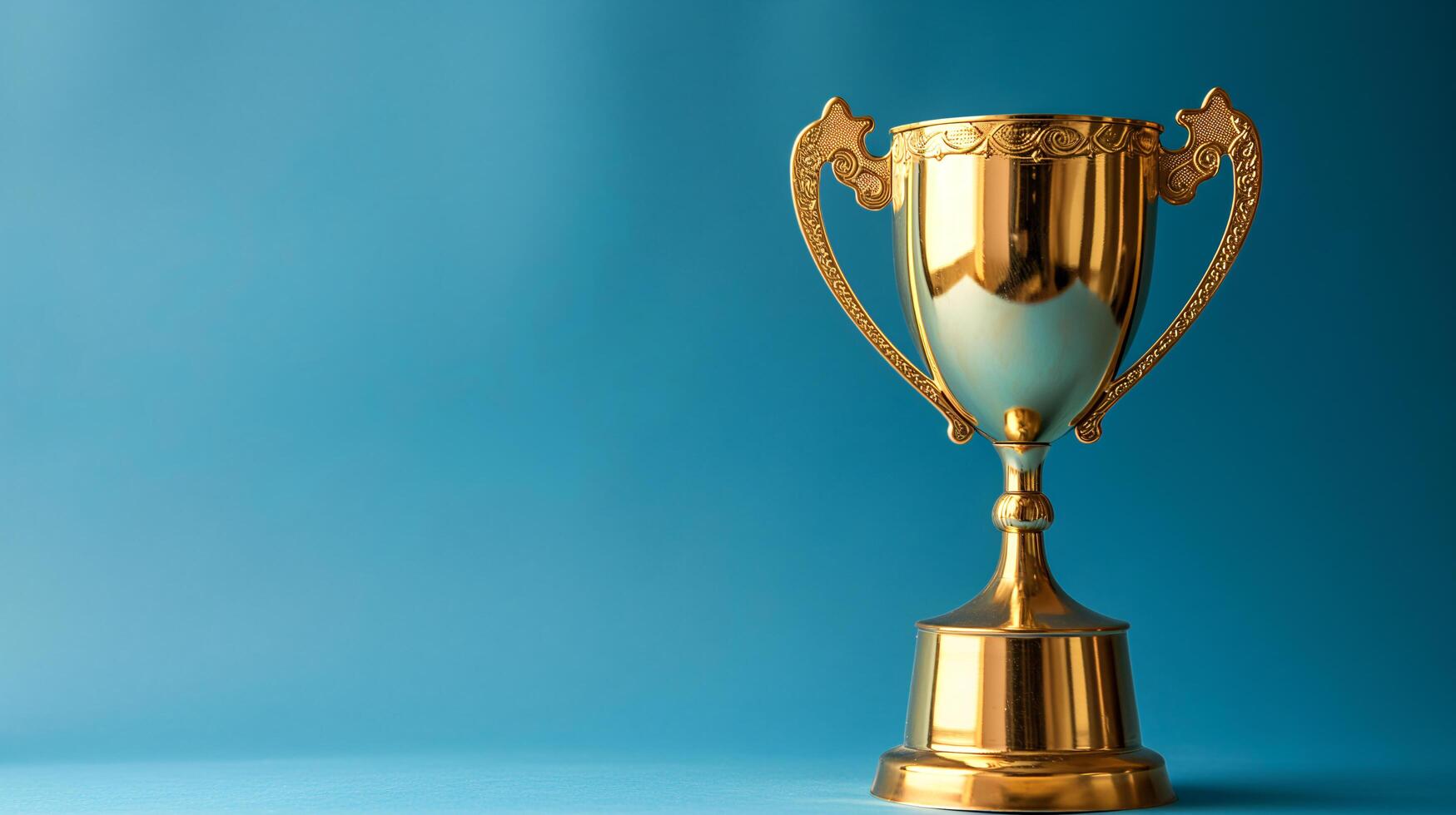 AI generated a golden trophy winner cup on blue background with copy space photo