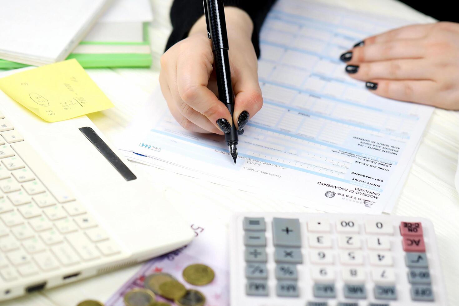 KYIV, UKRAINE - OCTOBER 31, 2023 Accountant fill italian tax form F24 Unified payment model in end of tax period. Taxation and paperwork routine photo