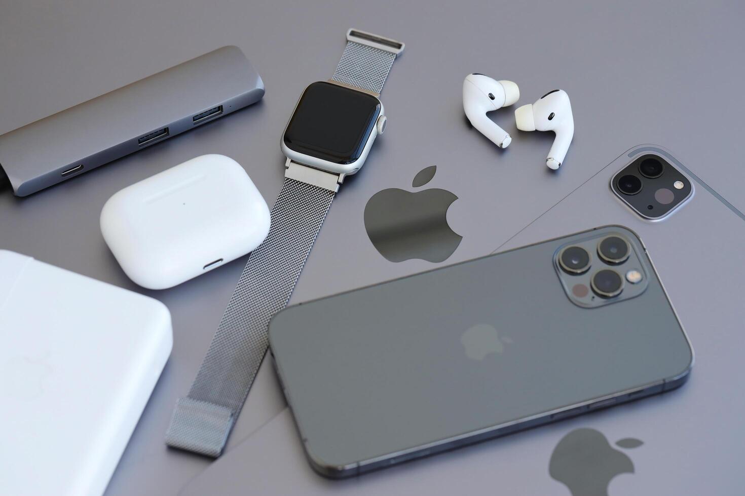 KYIV, UKRAINE - 4 MAY, 2023 Apple brand devices iphone, ipad and airpods with apple watch lies on macbook body photo