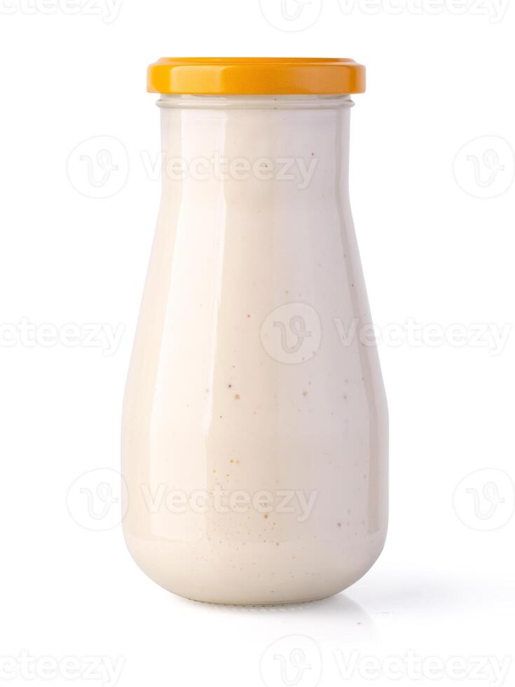 Bottle with tasty tartar sauce on white background photo