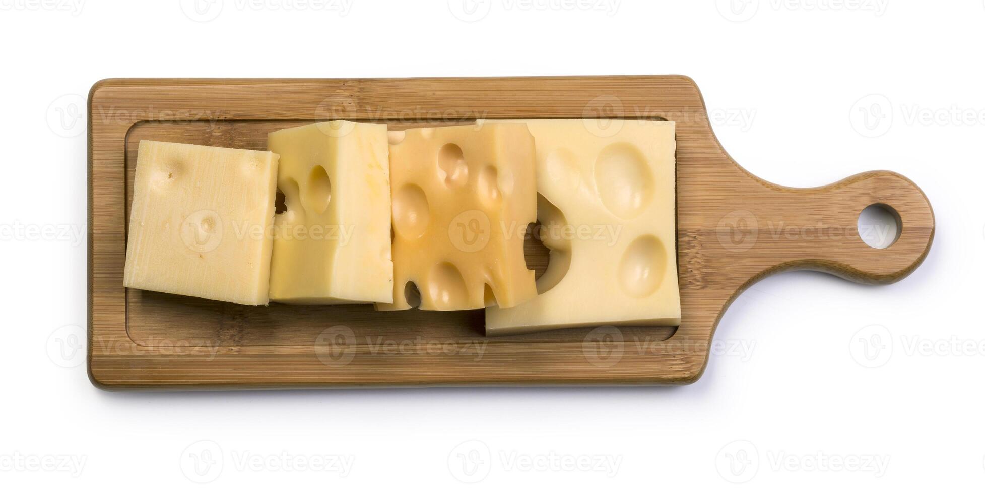 various types of cheese on wooden board photo