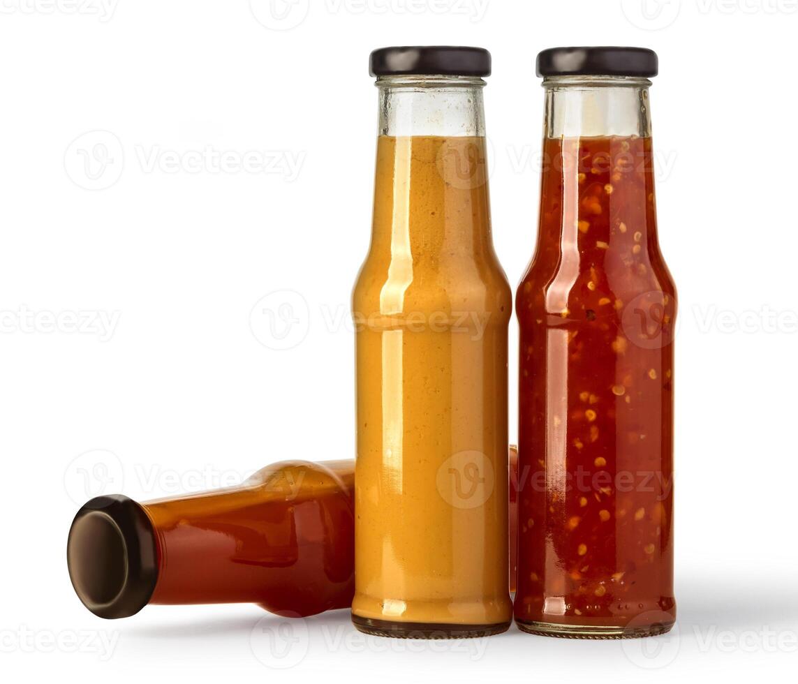 the various barbecue sauces in glass bottles photo