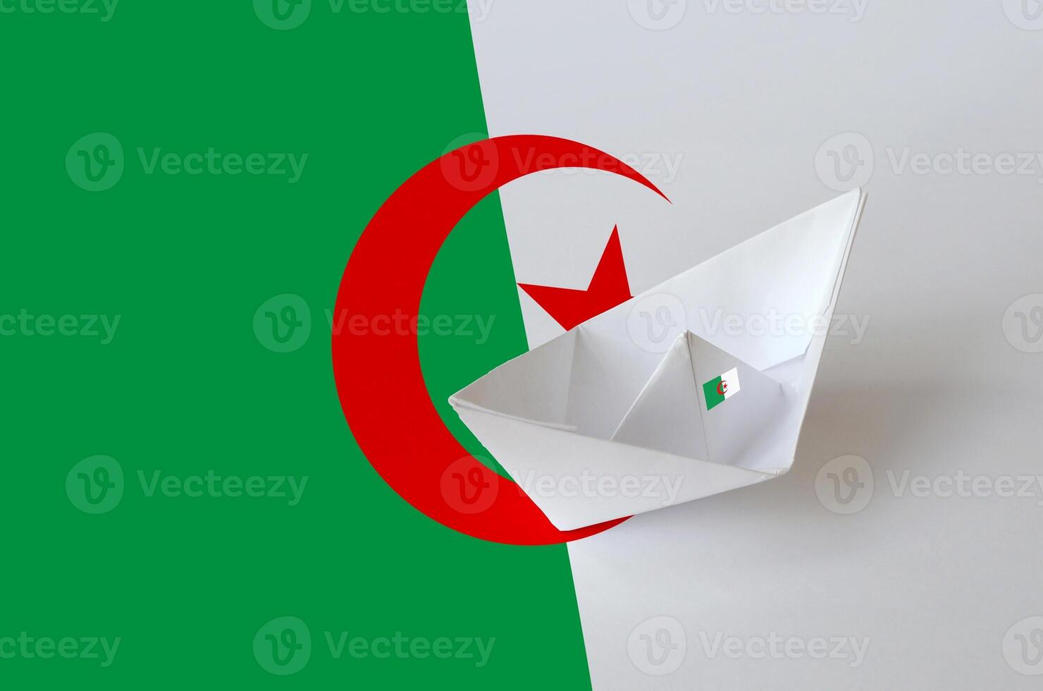 Algeria flag depicted on paper origami ship closeup. Handmade arts concept photo