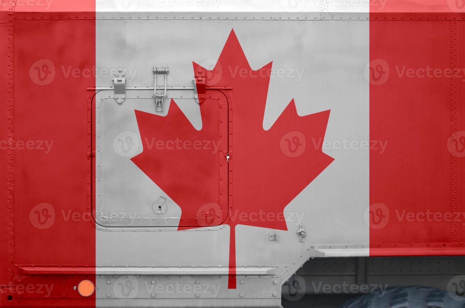 Canada flag depicted on side part of military armored truck closeup. Army forces conceptual background photo