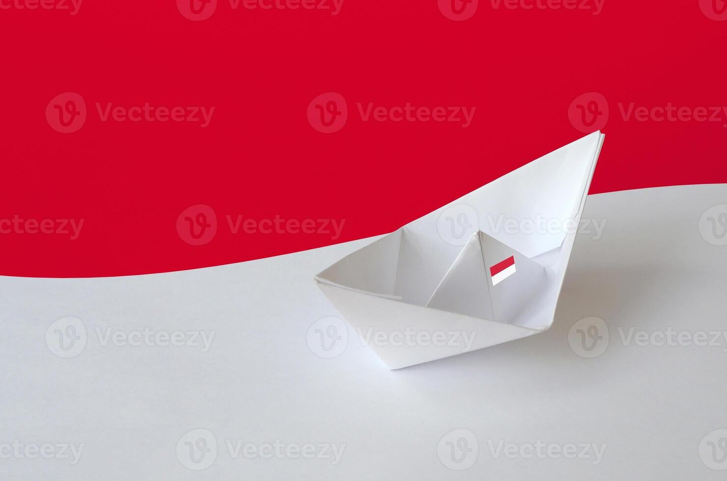 Monaco flag depicted on paper origami ship closeup. Handmade arts concept photo