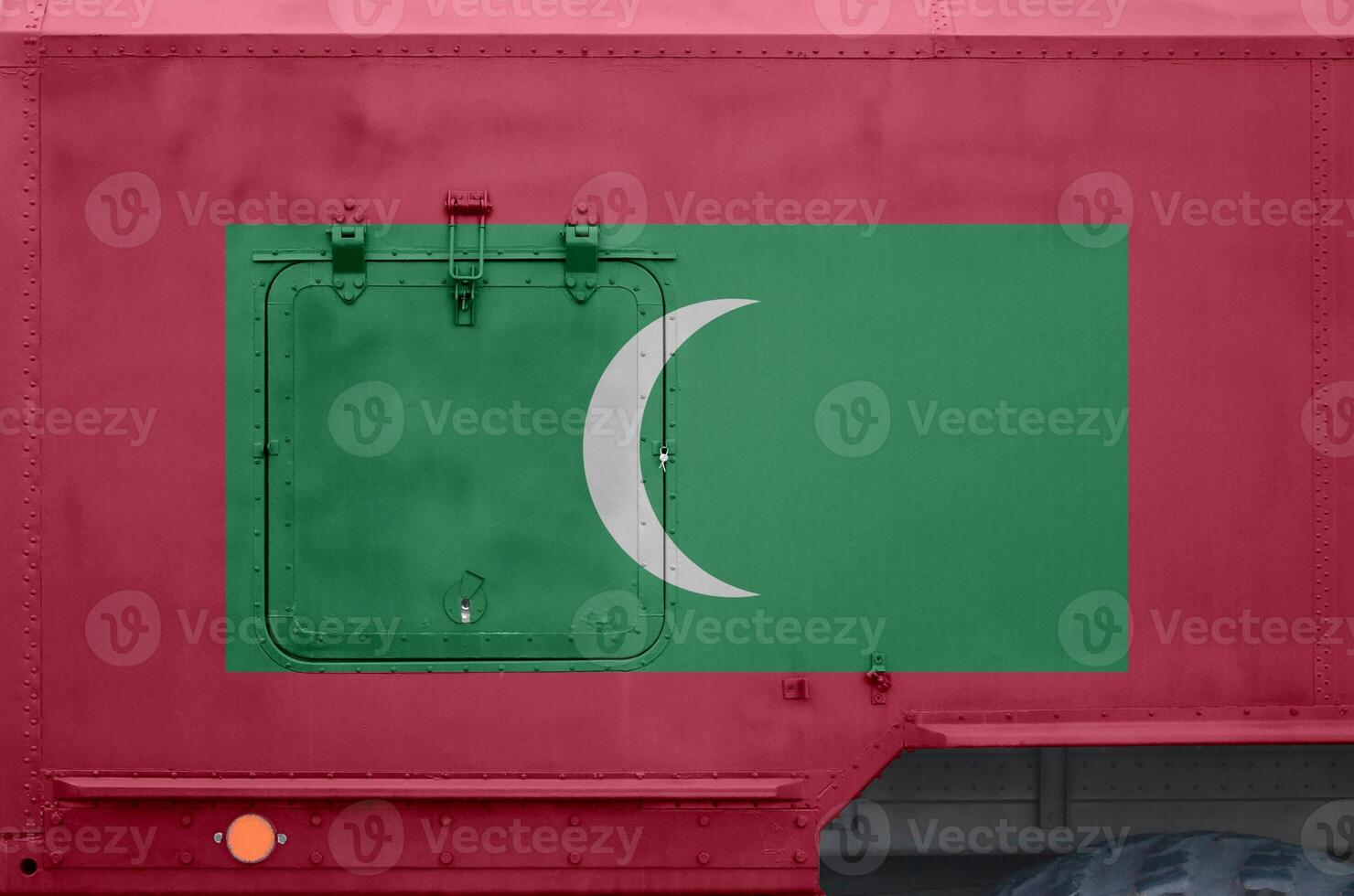 Maldives flag depicted on side part of military armored truck closeup. Army forces conceptual background photo