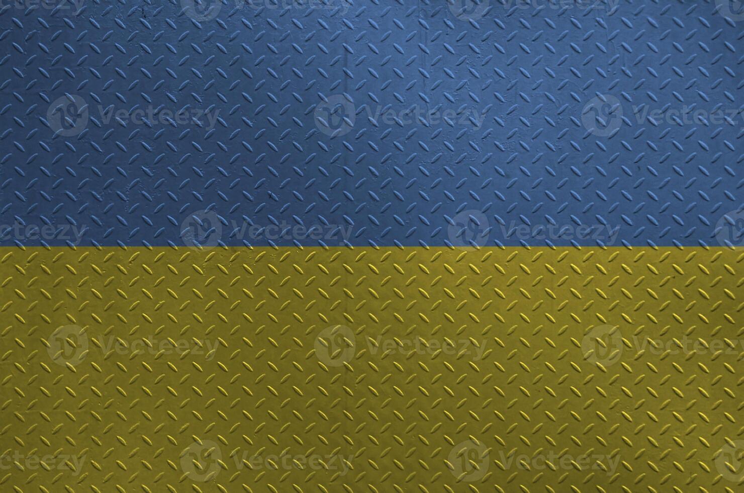 Ukraine flag depicted in paint colors on old brushed metal plate or wall closeup. Textured banner on rough background photo
