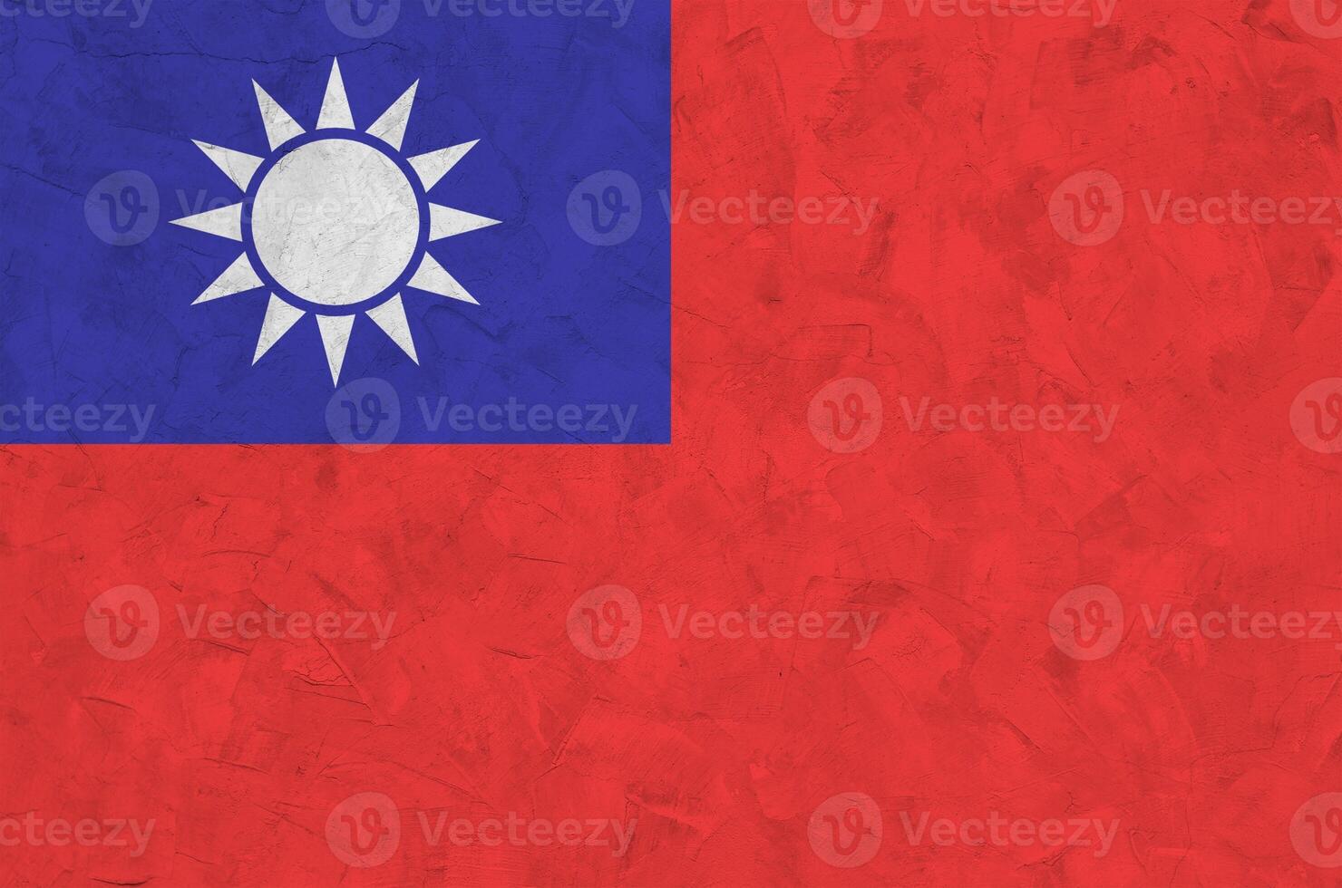 Taiwan flag depicted in bright paint colors on old relief plastering wall. Textured banner on rough background photo