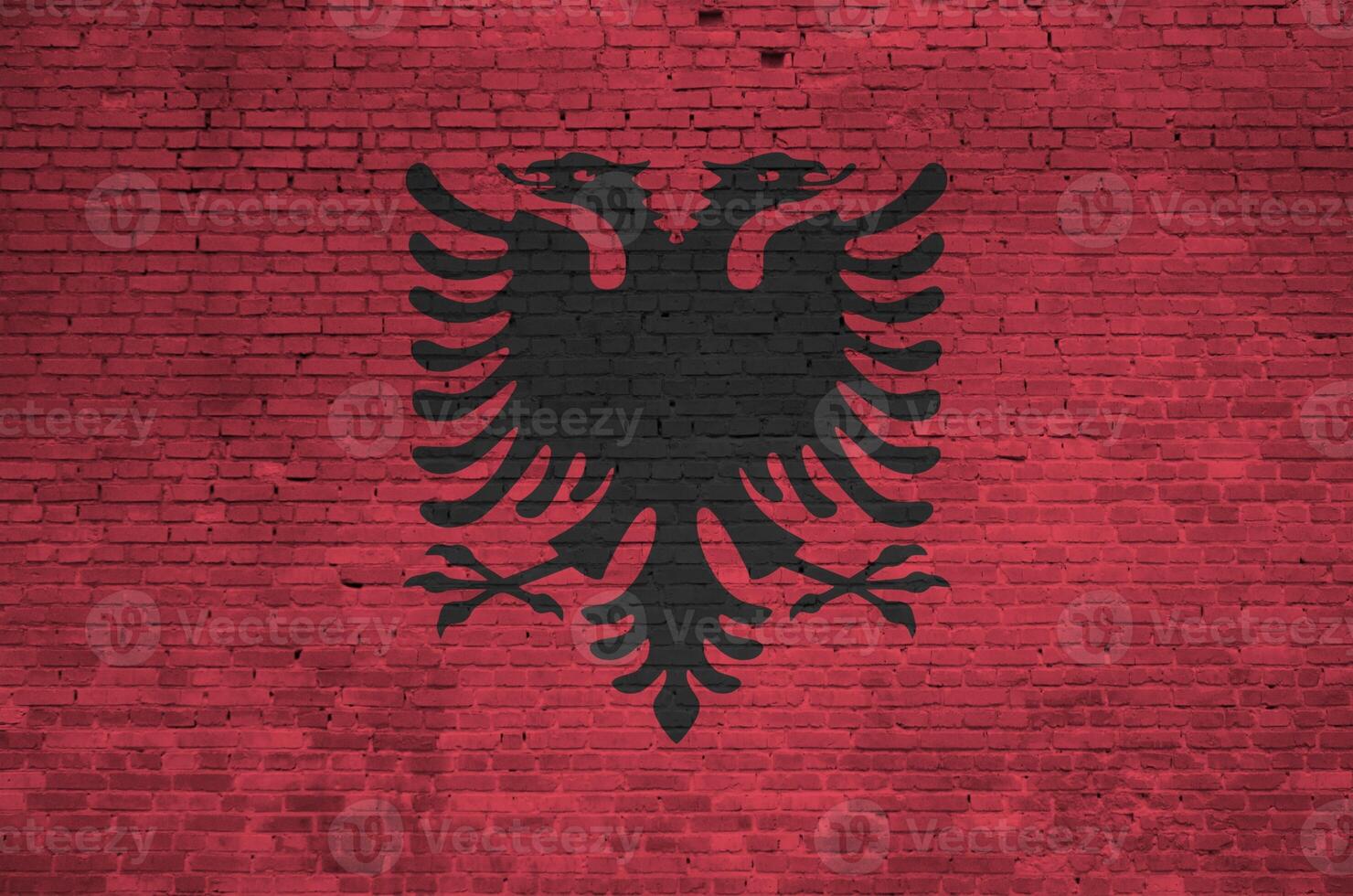 Albania flag depicted in paint colors on old brick wall. Textured banner on big brick wall masonry background photo