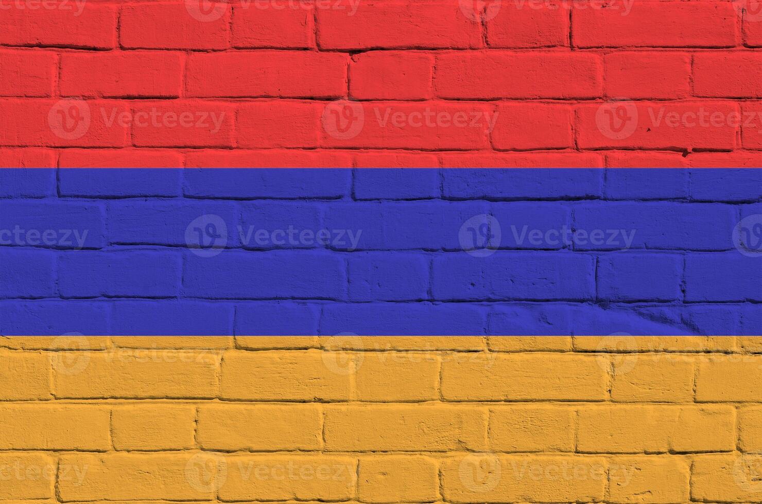 Armenia flag depicted in paint colors on old brick wall. Textured banner on big brick wall masonry background photo