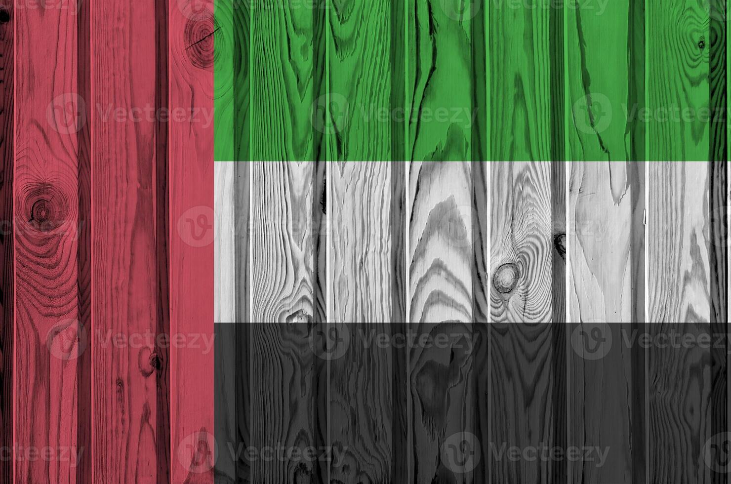 United Arab Emirates flag depicted in bright paint colors on old wooden wall. Textured banner on rough background photo