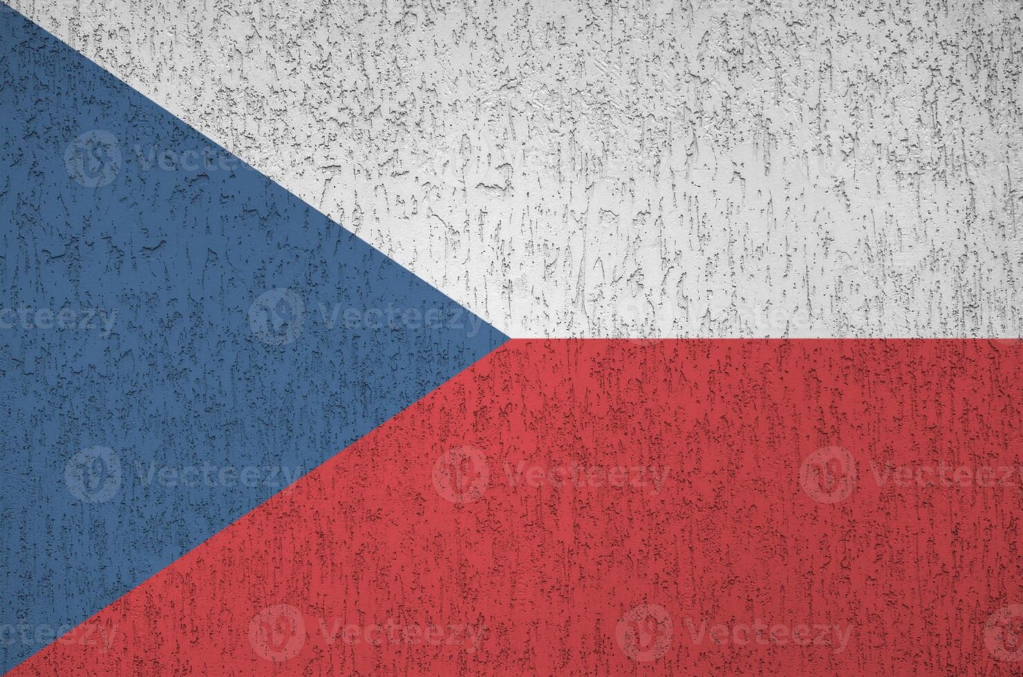 Czech flag depicted in bright paint colors on old relief plastering wall. Textured banner on rough background photo