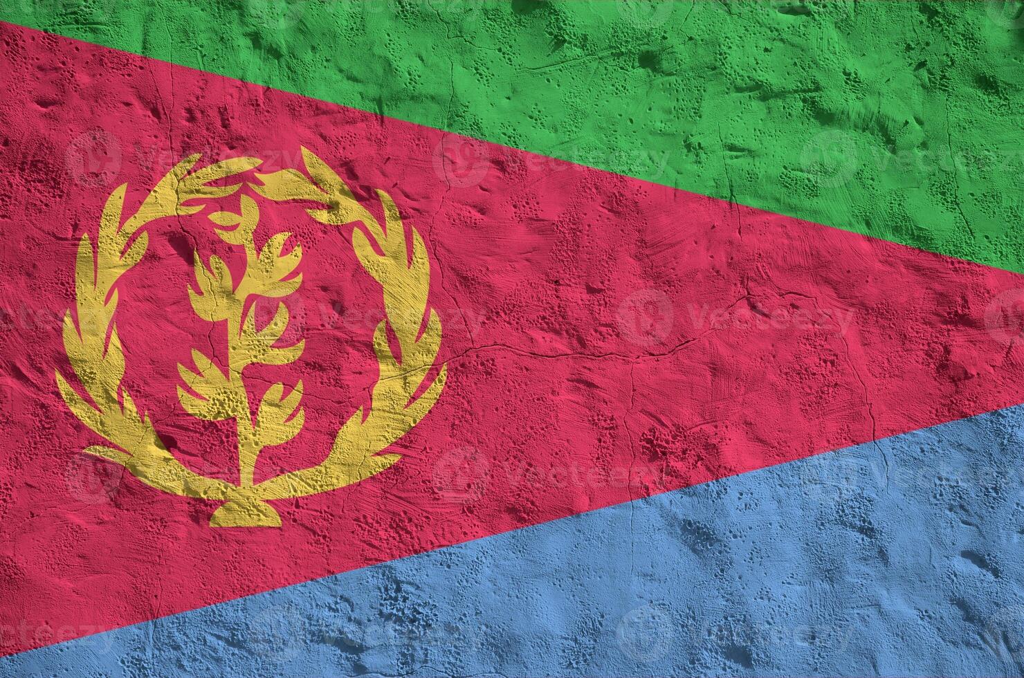 Eritrea flag depicted in bright paint colors on old relief plastering wall. Textured banner on rough background photo