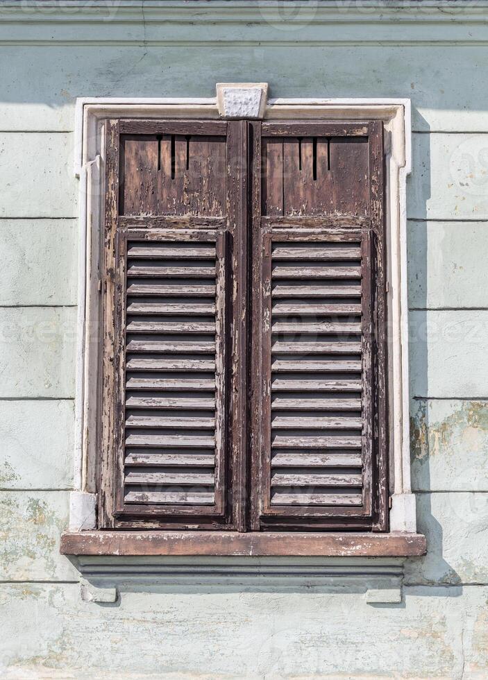 window with closed shutters photo