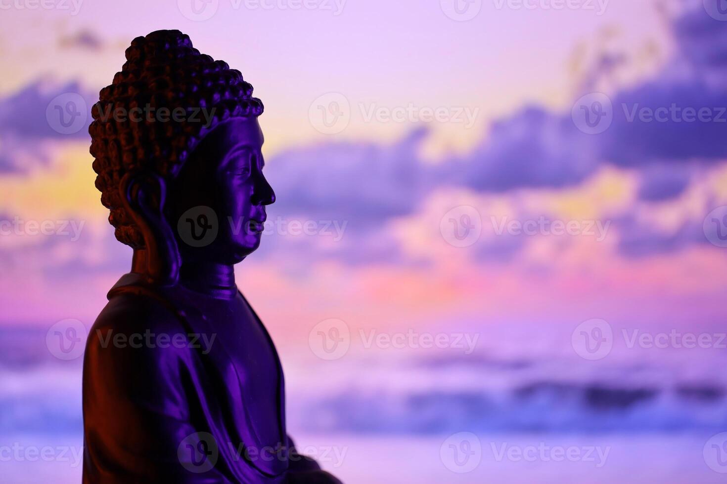 Buddha Purnima and Vesak day concept, Buddha statue with low key light against beautiful and colorful background. Meditation photo