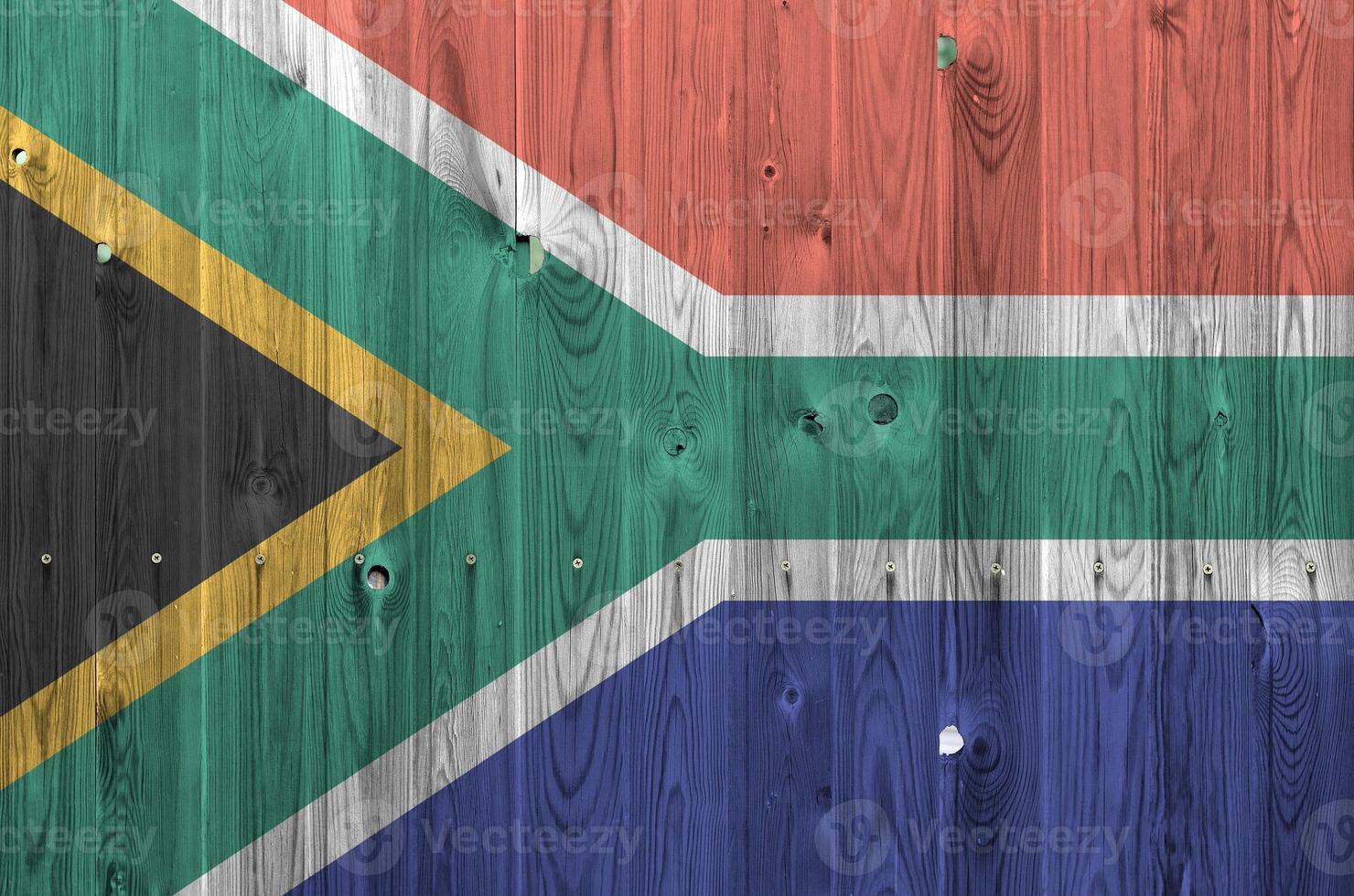 South Africa flag depicted in bright paint colors on old wooden wall. Textured banner on rough background photo