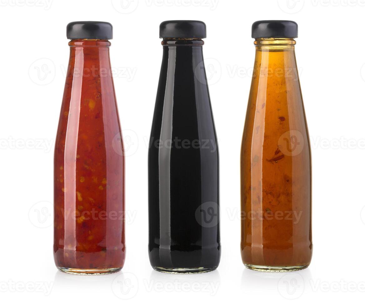 the various barbecue sauces in glass bottles photo