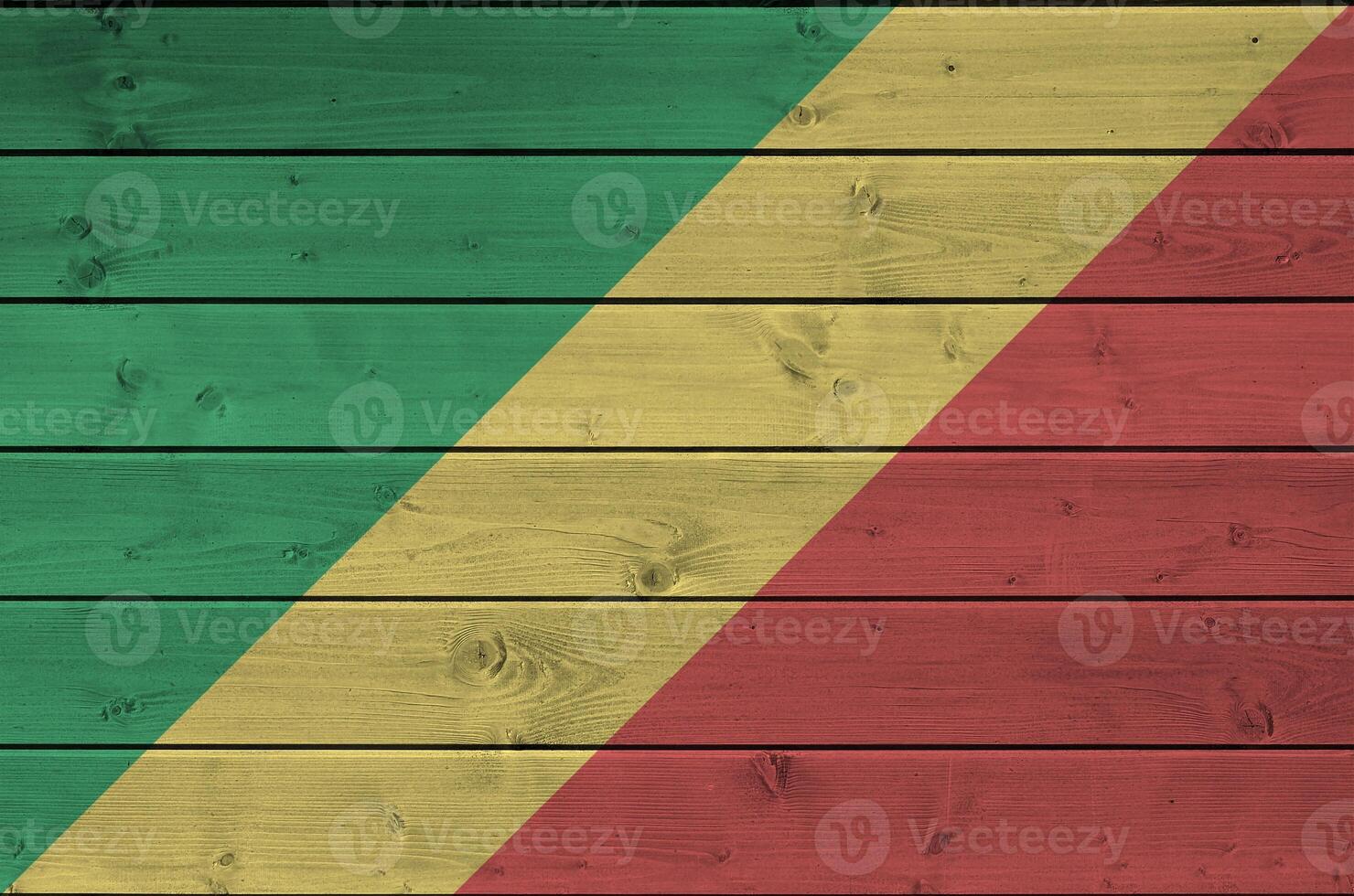 Congo flag depicted in bright paint colors on old wooden wall. Textured banner on rough background photo