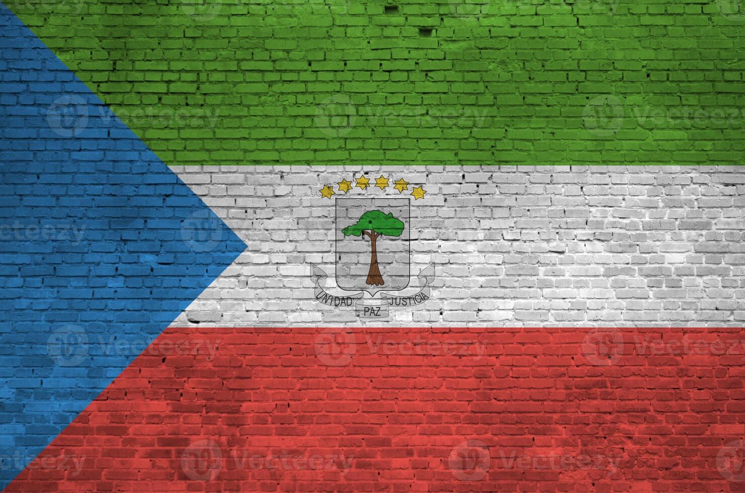 Equatorial Guinea flag depicted in paint colors on old brick wall. Textured banner on big brick wall masonry background photo