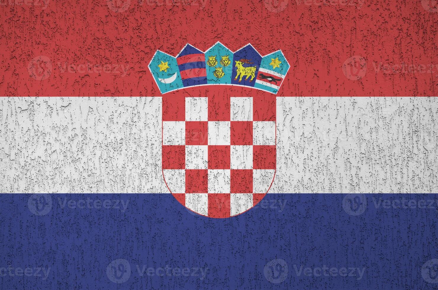 Croatia flag depicted in bright paint colors on old relief plastering wall. Textured banner on rough background photo