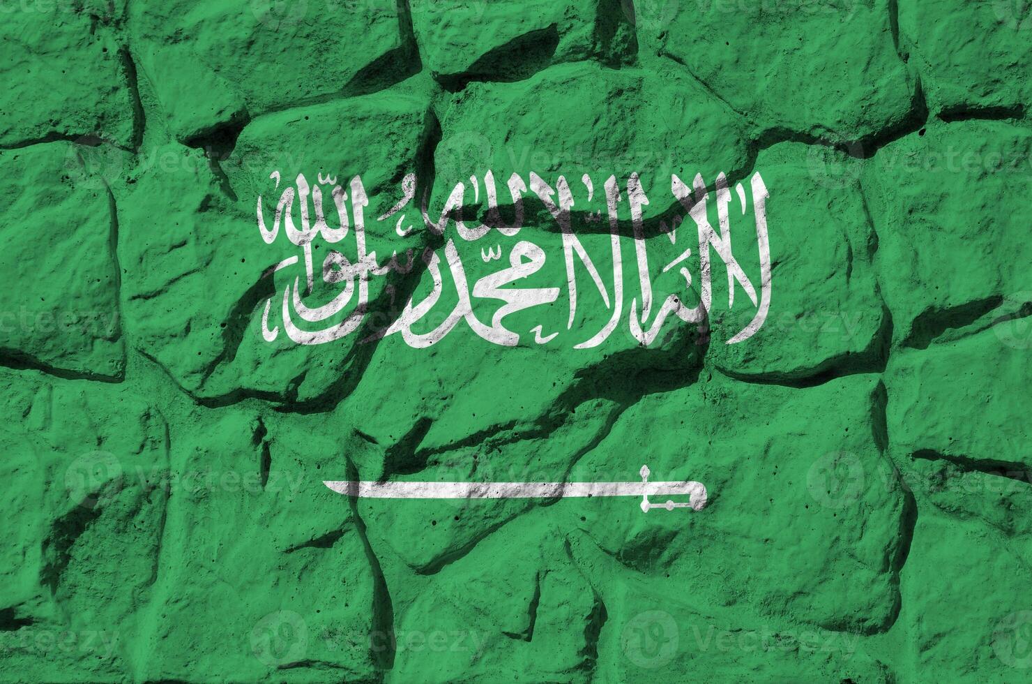 Saudi Arabia flag depicted in paint colors on old stone wall closeup. Textured banner on rock wall background photo