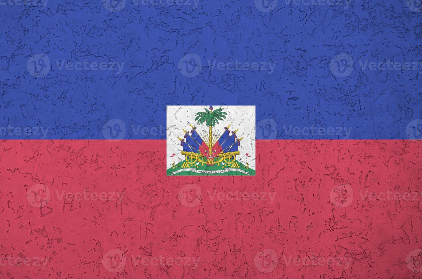 Haiti flag depicted in bright paint colors on old relief plastering wall. Textured banner on rough background photo