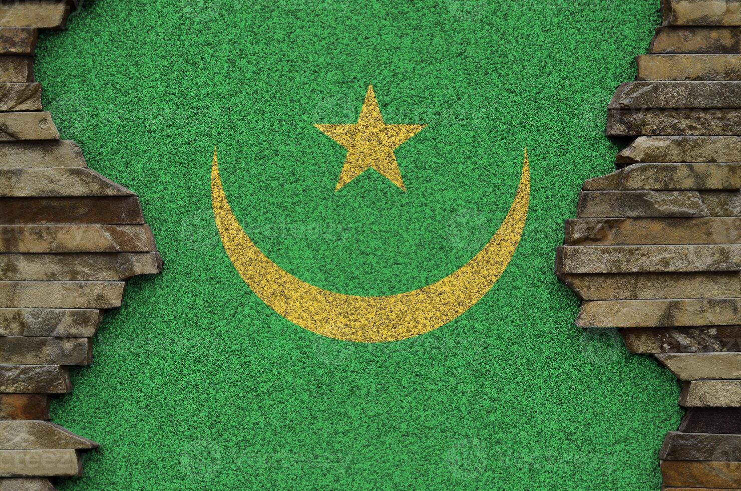 Mauritania flag depicted in paint colors on old stone wall closeup. Textured banner on rock wall background photo