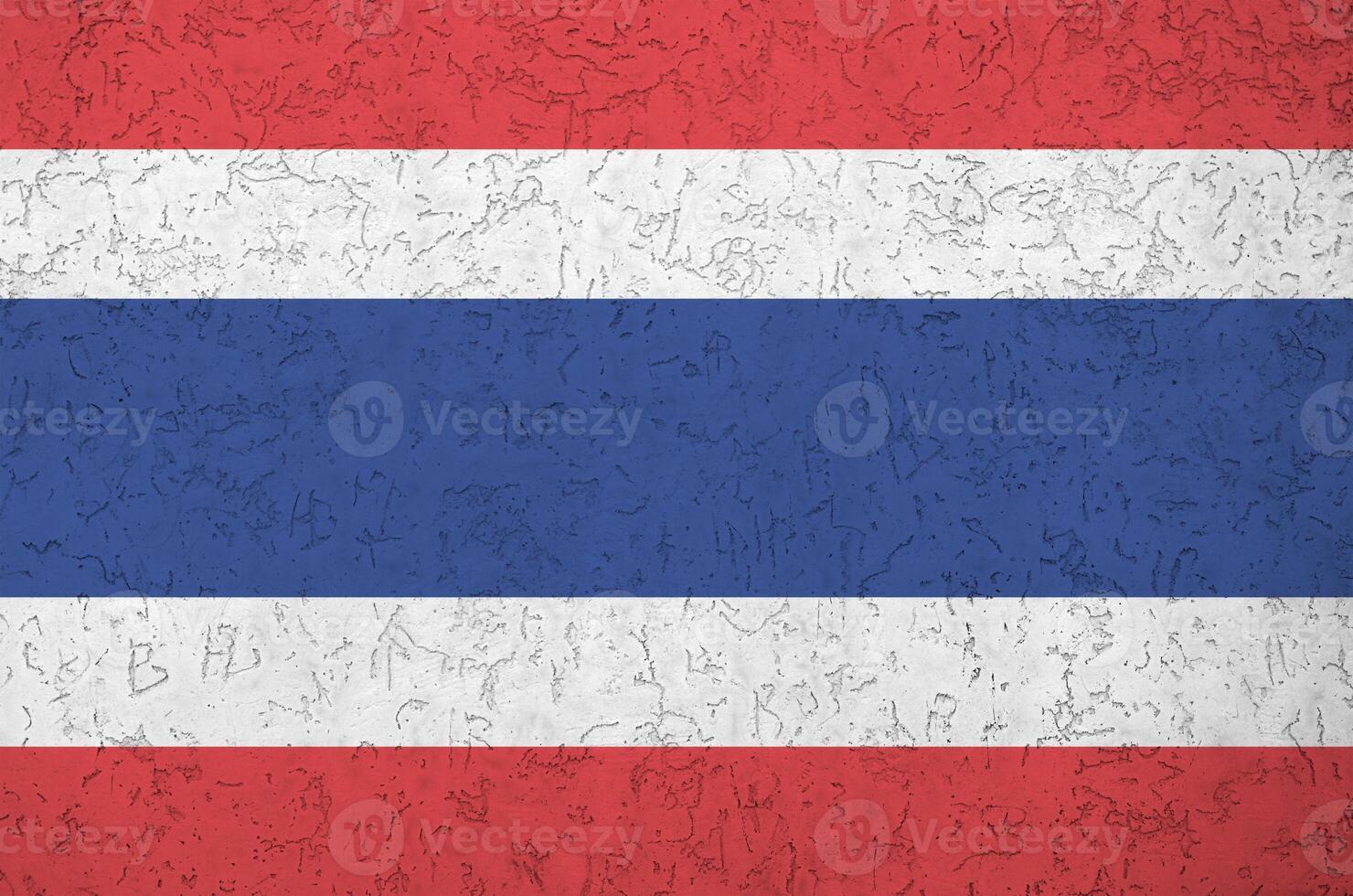 Thailand flag depicted in bright paint colors on old relief plastering wall. Textured banner on rough background photo