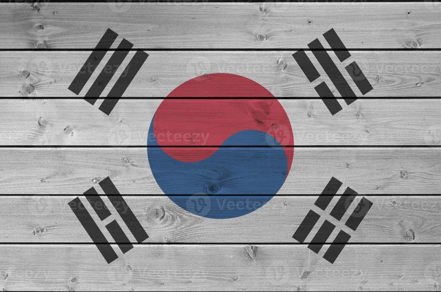 South Korea flag depicted in bright paint colors on old wooden wall. Textured banner on rough background photo