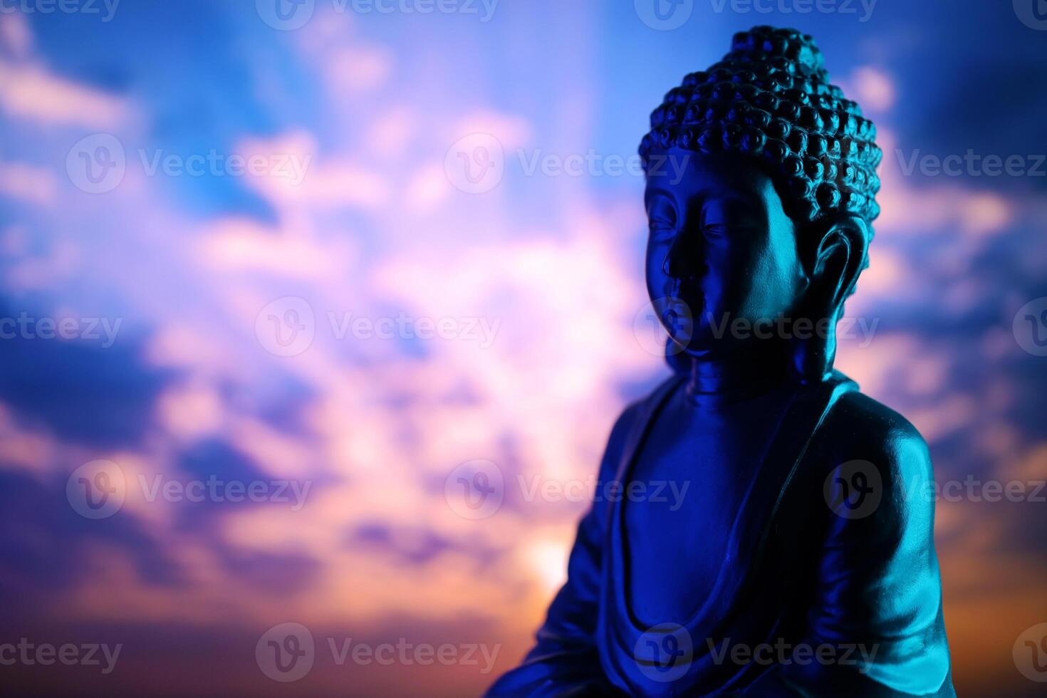 Buddha Purnima and Vesak day concept, Buddha statue with low key light against beautiful and colorful background. Meditation photo