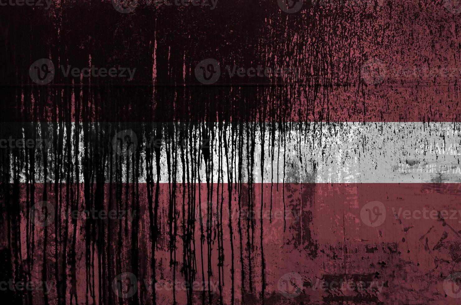 Latvia flag depicted in paint colors on old and dirty oil barrel wall closeup. Textured banner on rough background photo