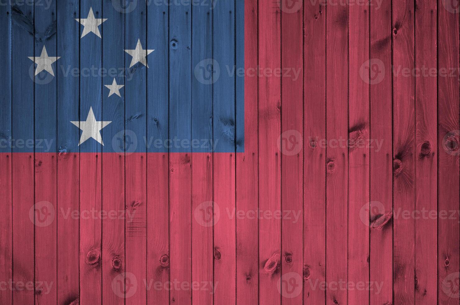 Samoa flag depicted in bright paint colors on old wooden wall. Textured banner on rough background photo