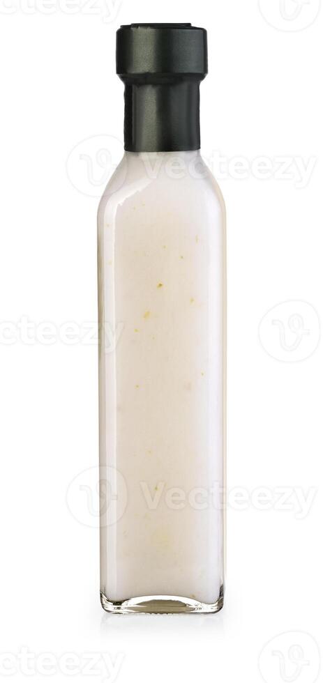 Garlic sauce in a bottle on white background photo