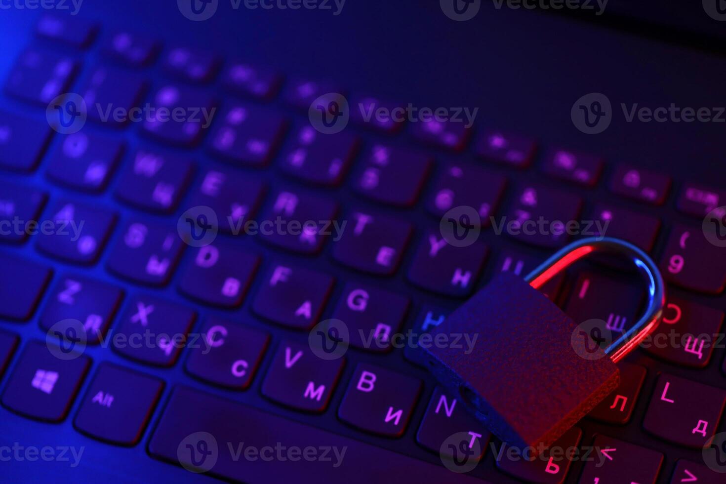 Computer security concept with a closed padlock on the keyboard. Padlock on top of a laptop keyboard. Selective focus photo