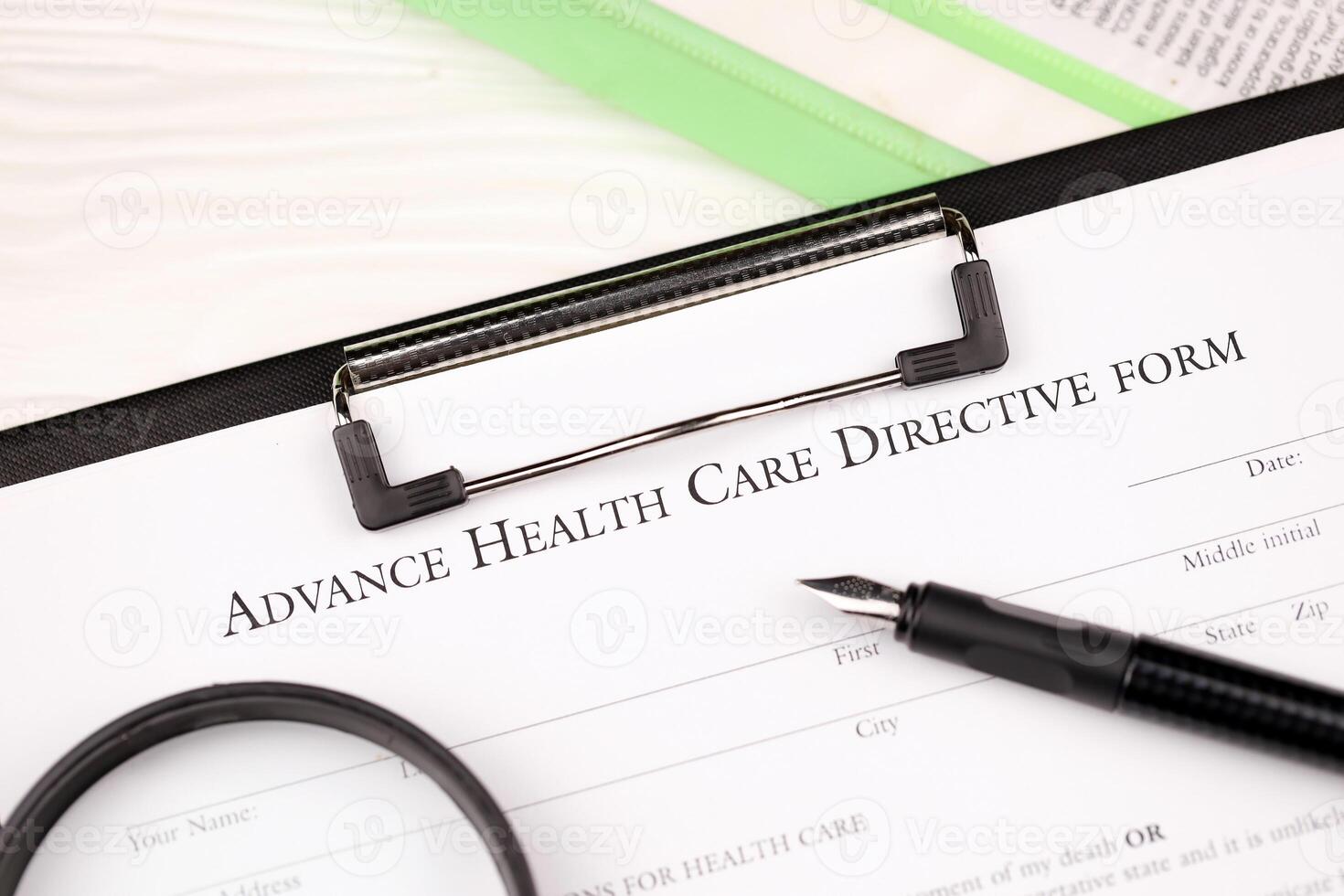 Advance health care directive blank form on A4 tablet lies on office table with pen and magnifying glass photo