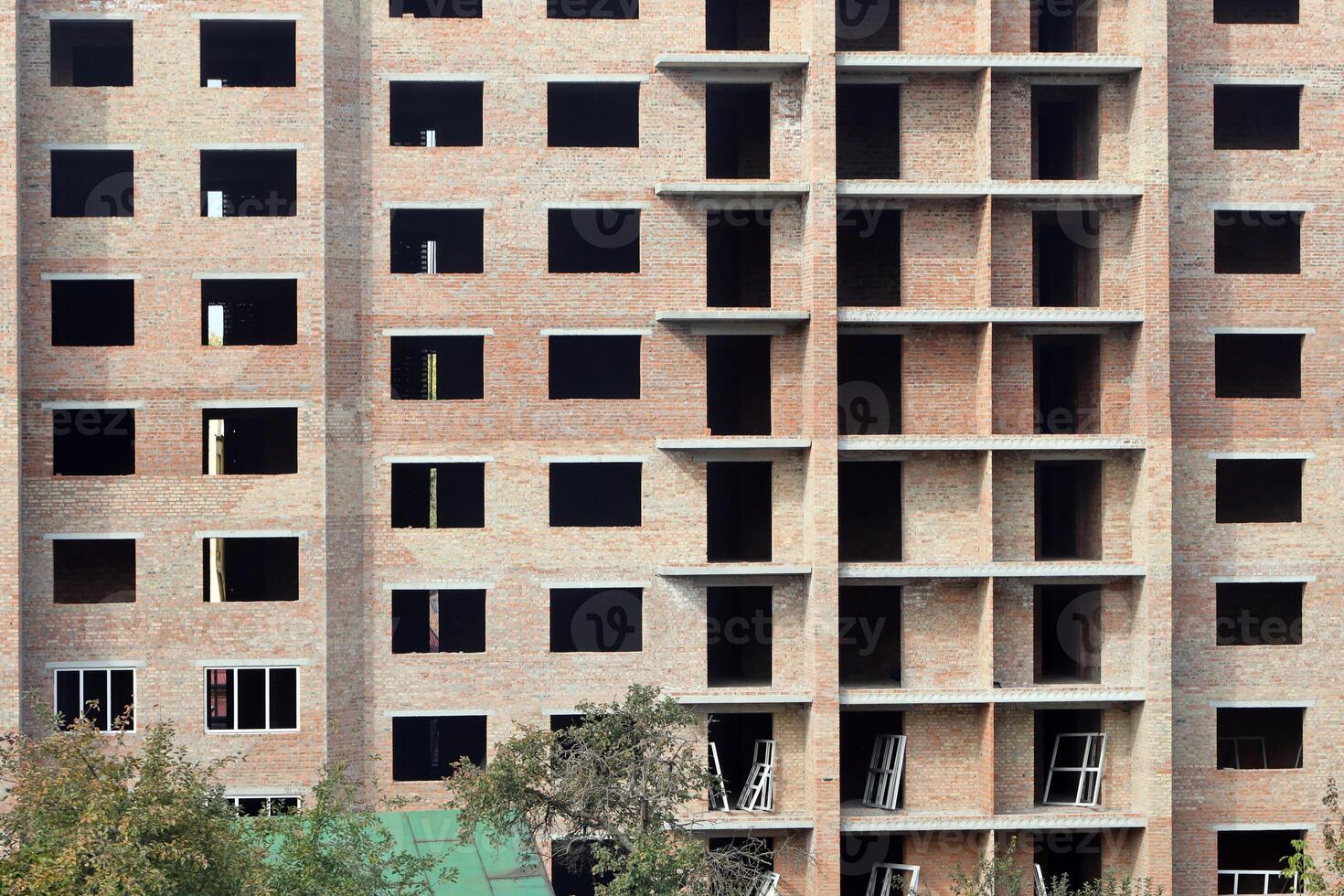 View of a large construction site with buildings under construction and multi-storey residential homes. Housing renovation photo