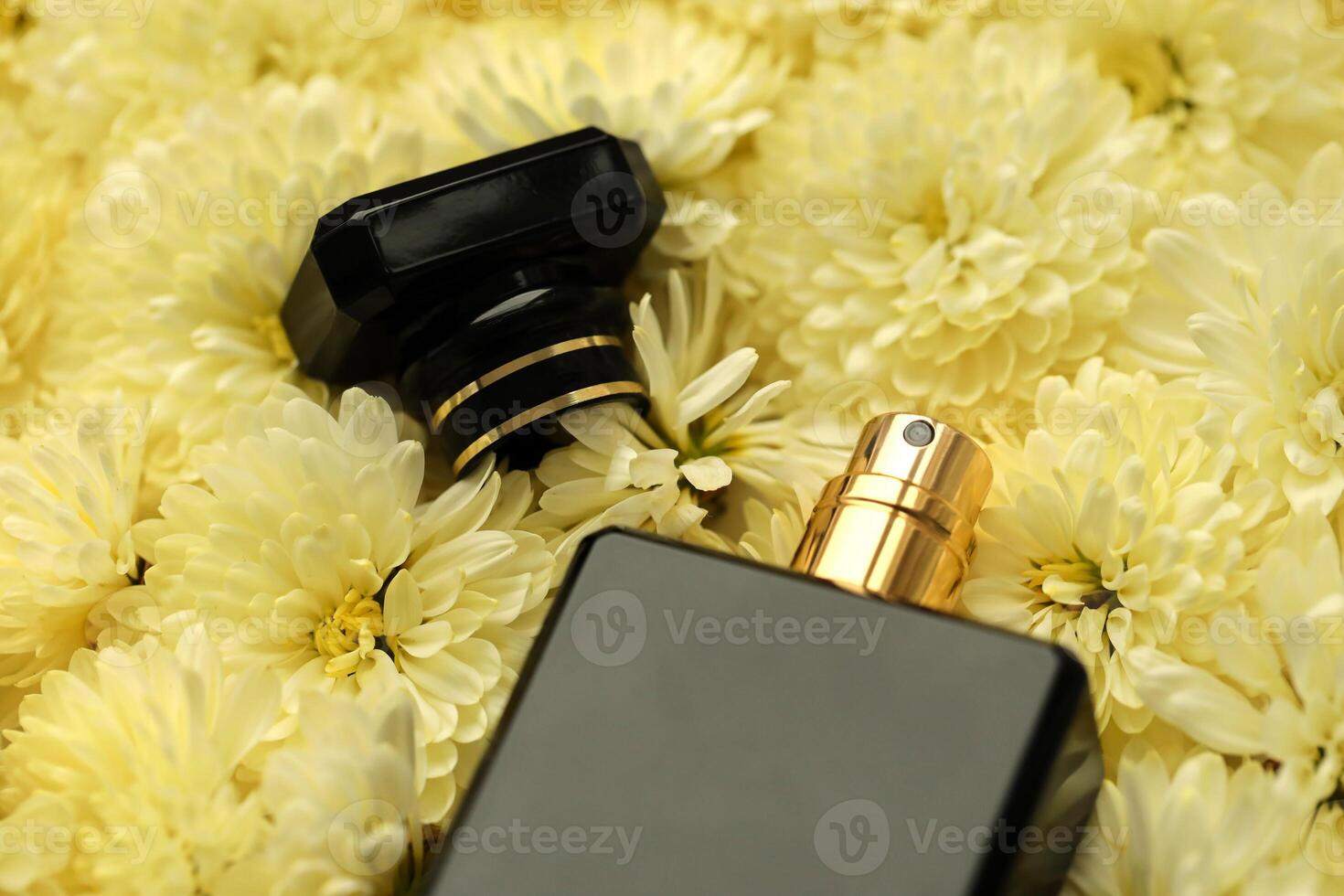 Women fragrance perfume bottle with flowers background close up. Unnamed blank sprayer bottle of perfume photo