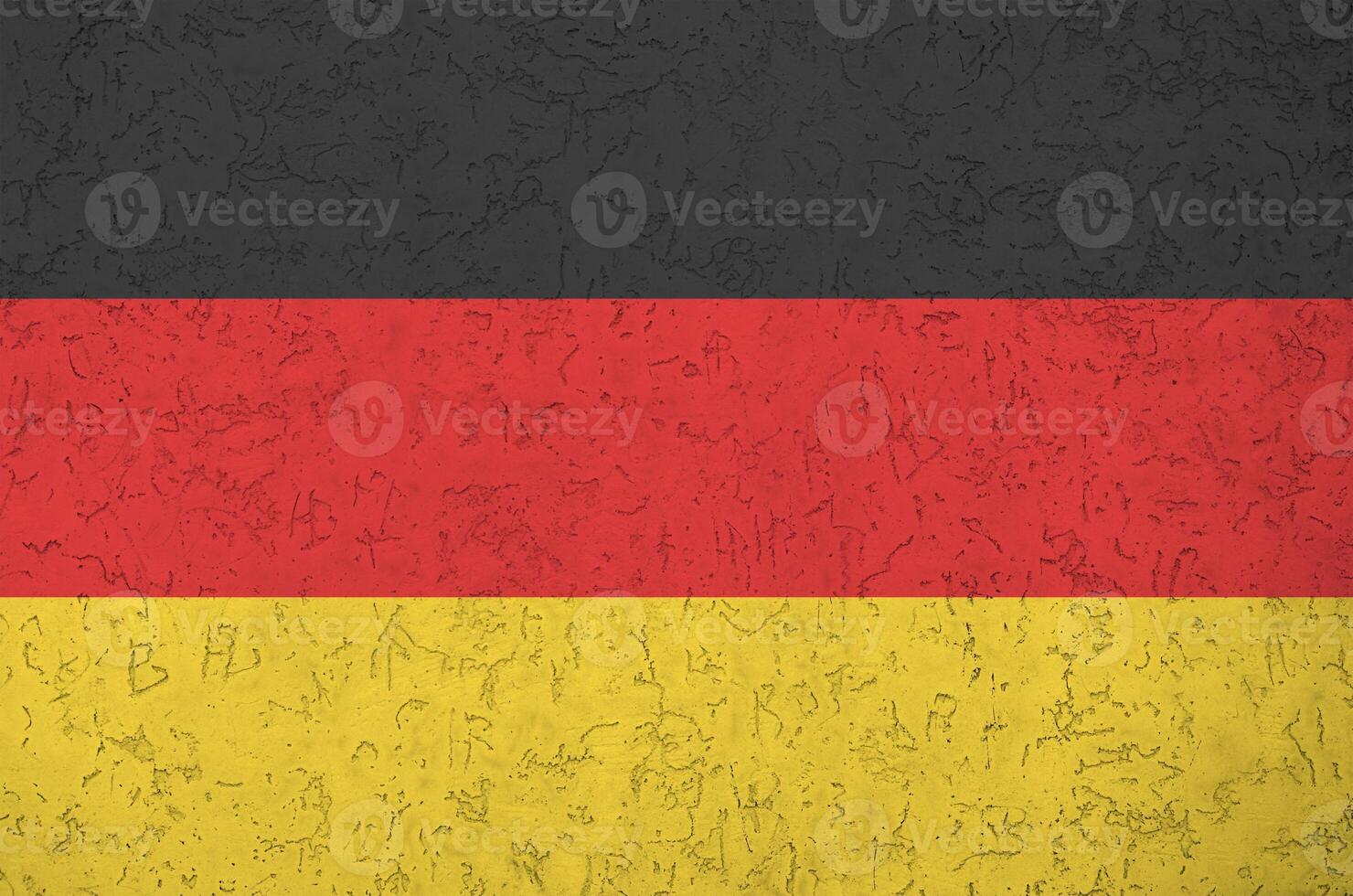 Germany flag depicted in bright paint colors on old relief plastering wall. Textured banner on rough background photo