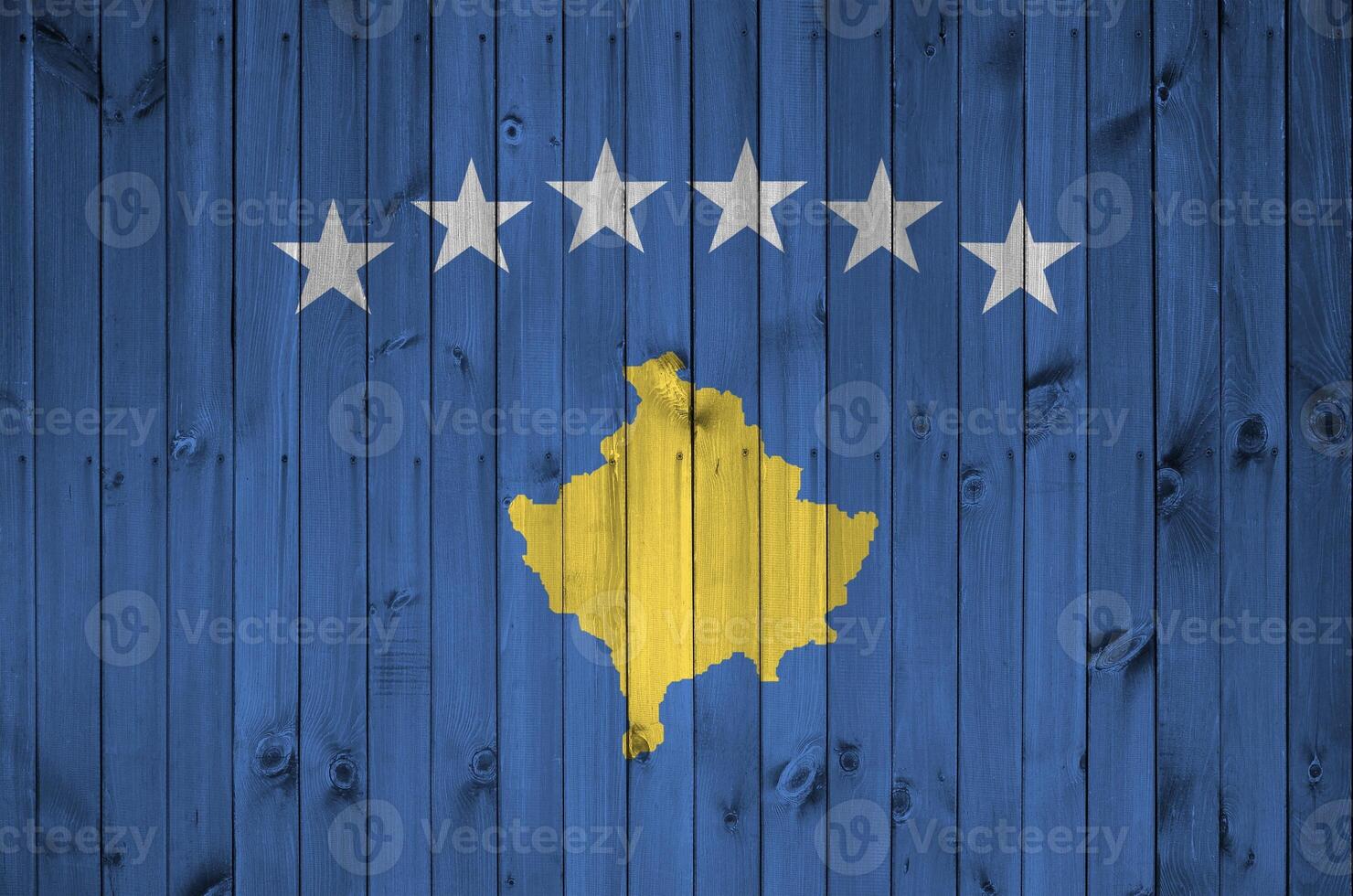 Kosovo flag depicted in bright paint colors on old wooden wall. Textured banner on rough background photo