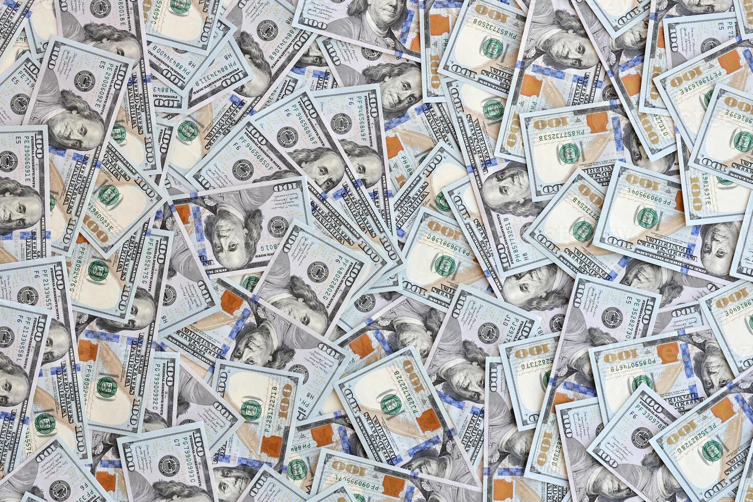 Very big amount of US hundred dollar bills. Huge quantity of united states currency notes on flat table photo