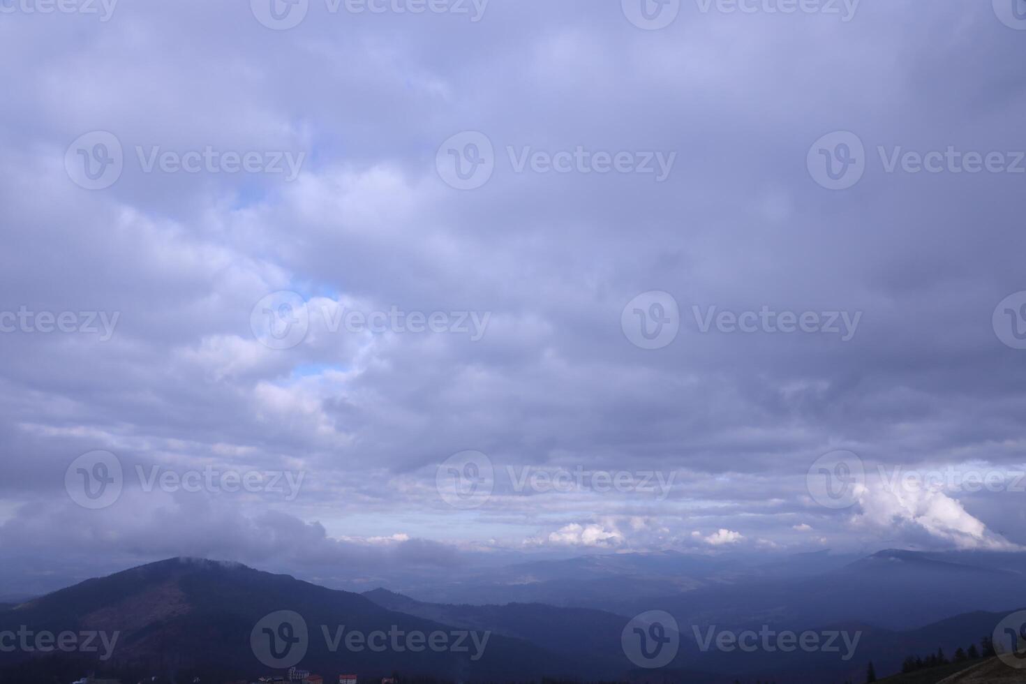 Morning view from the Dragobrat mountain peaks in Carpathian mountains, Ukraine. Cloudy and foggy landscape around Drahobrat Peaks photo