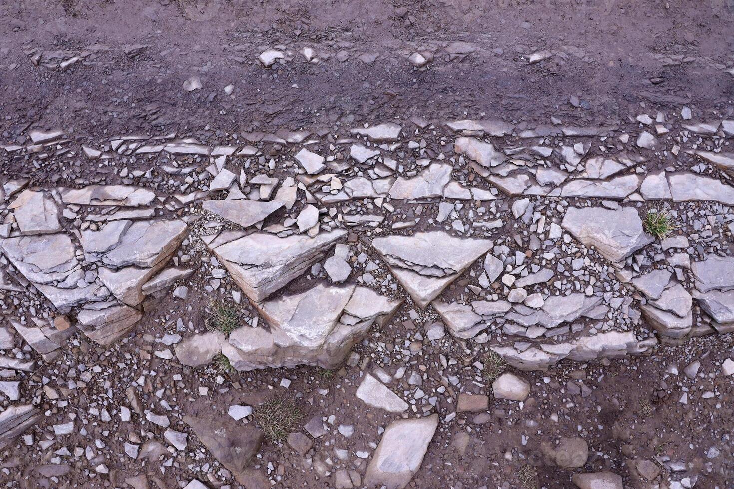 Background of shattered stony stones surface in mountain area. Texture with natural light photo