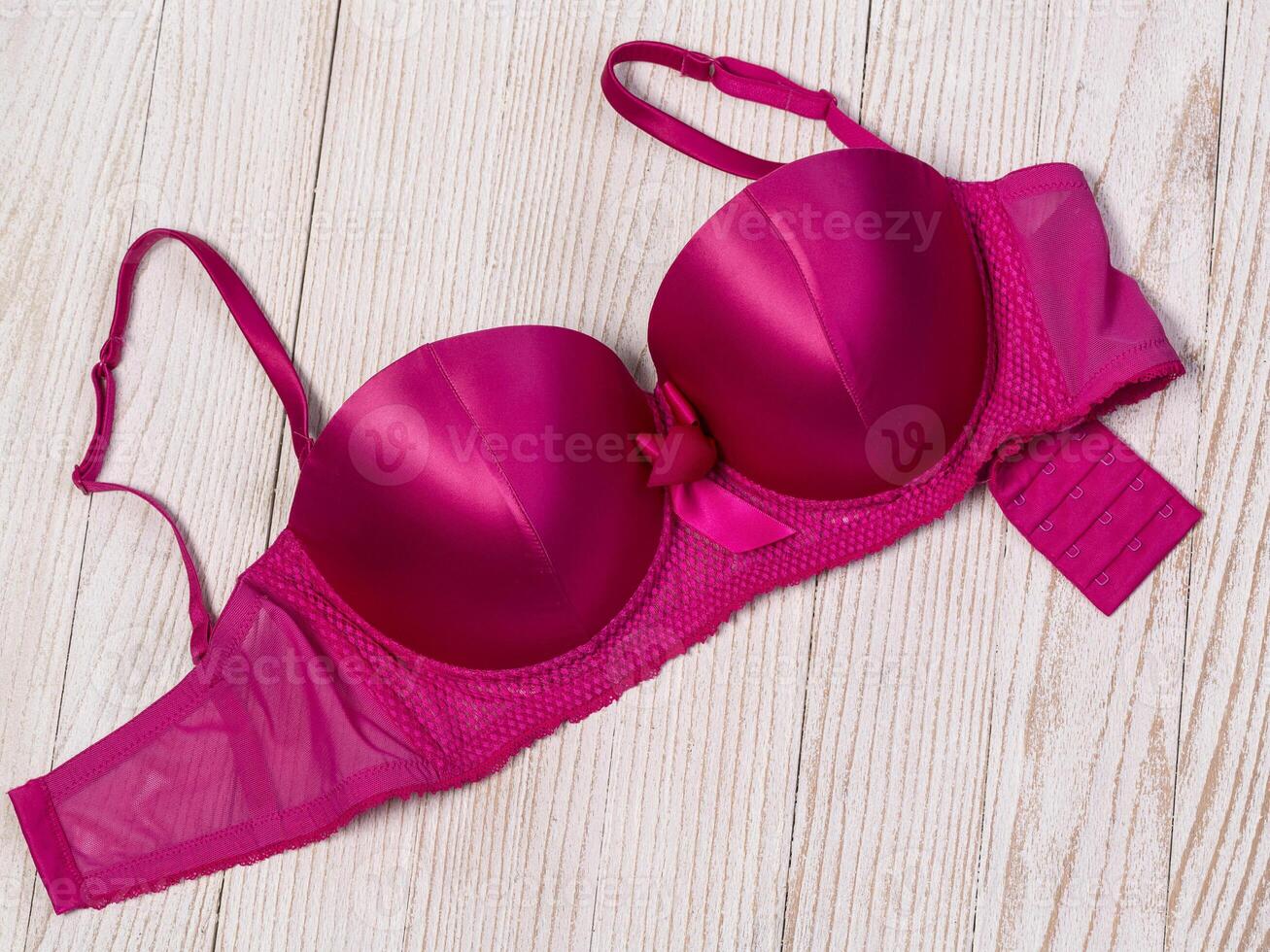 Pink bra on a wooden  background photo