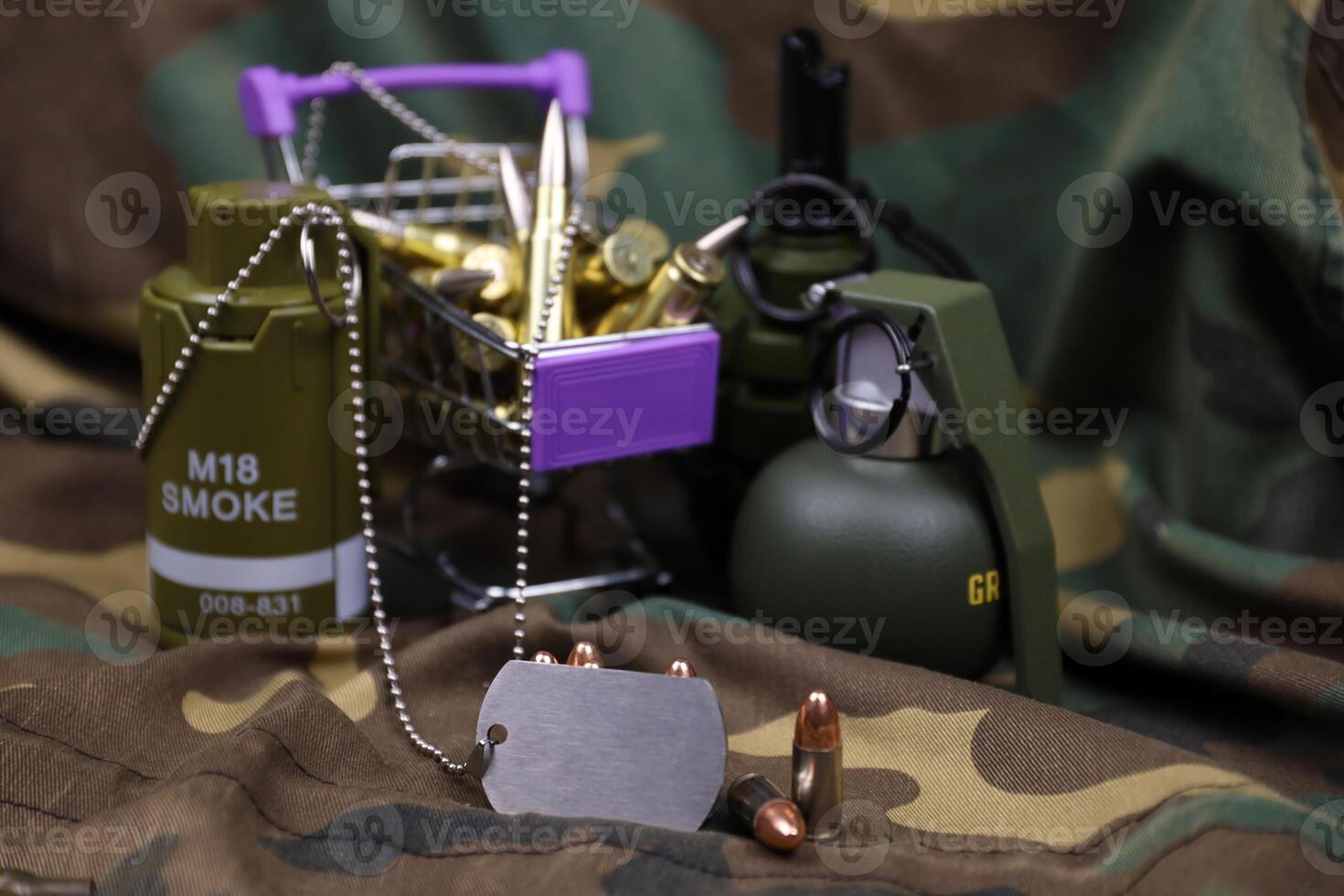 Rifle cartridges in small shopping cart. Big caliber ammo cartridges and hand grenades with a small shopping basket photo