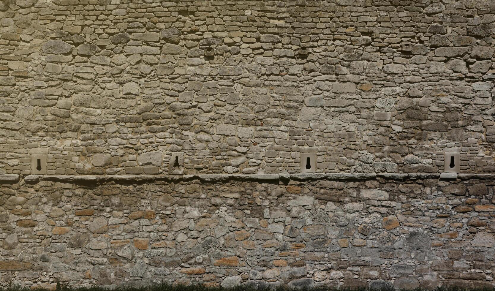 Very old brick stone wall of castle or fortress of 18th century. Full frame wall with obsolete dirty and cracked bricks photo