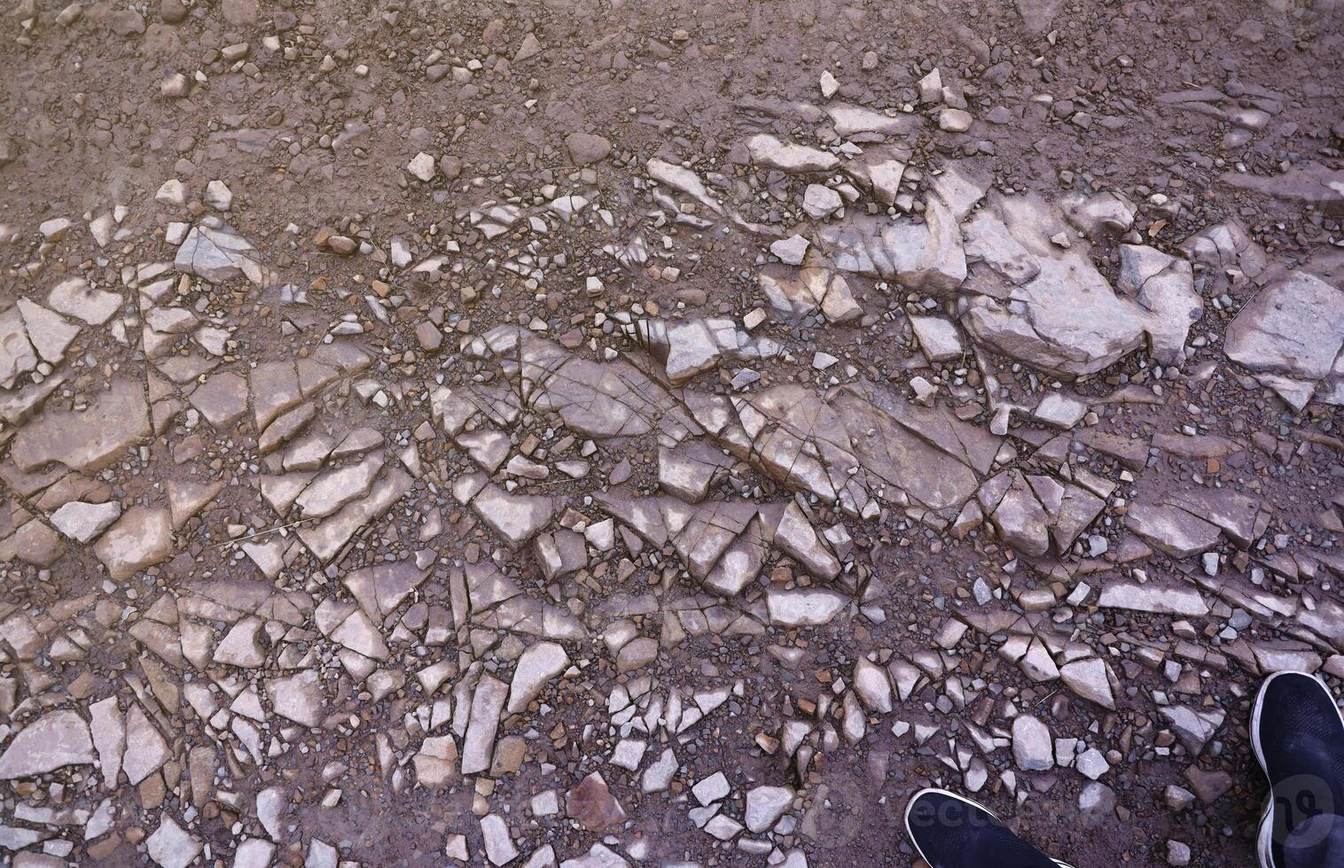 Background of shattered stony stones surface in mountain area. Texture with natural light photo