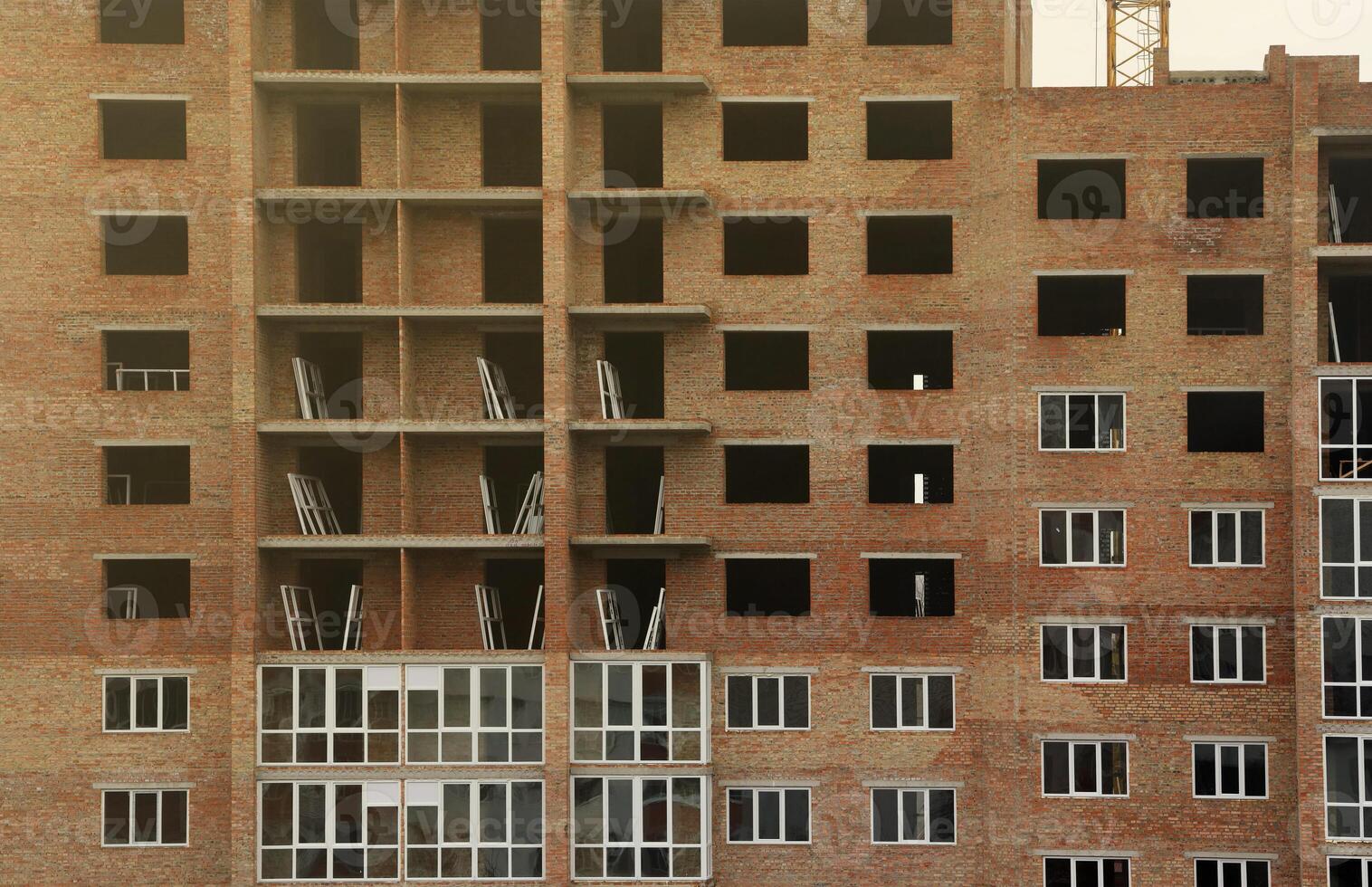 View of a large construction site with buildings under construction and multi-storey residential homes. Housing renovation photo