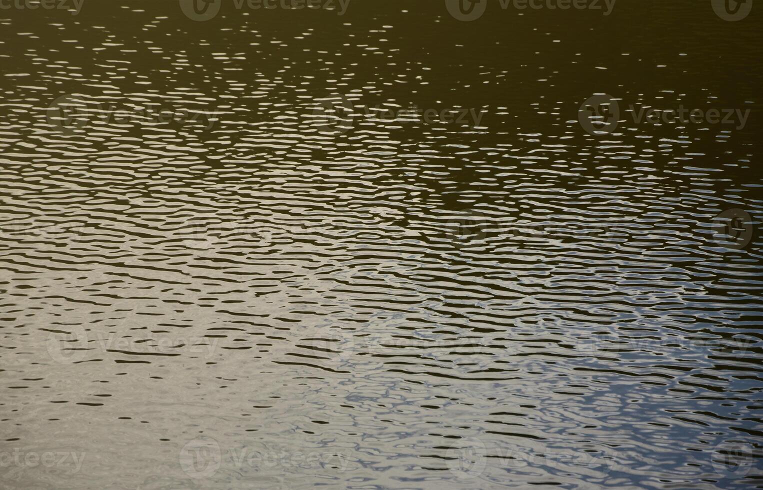 The texture of dark river water under the influence of wind, imprinted in perspective. Horizontal image photo