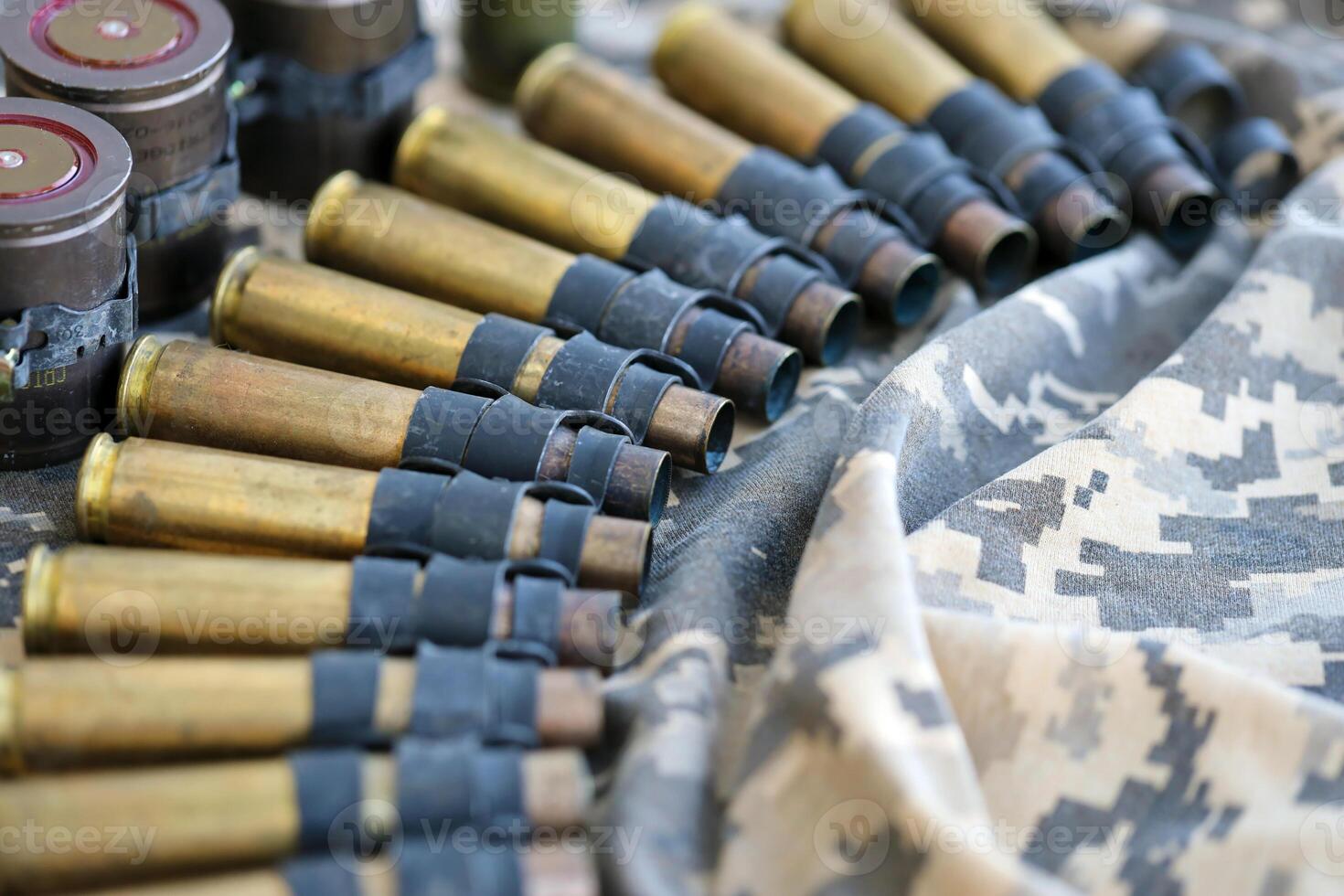 Ukrainian army fabric and machine gun belt shells lies on ukrainian pixeled military camouflage photo