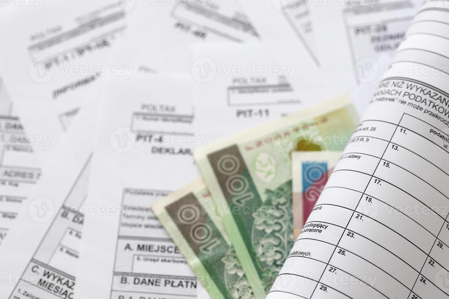 Polish zloty money on big amount of polish tax forms close up. Accounting, bureaucracy and taxpayers routine photo